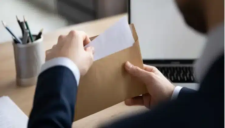 A business person preparing an envelope with billing information and sending it to the recipient's shipping address.